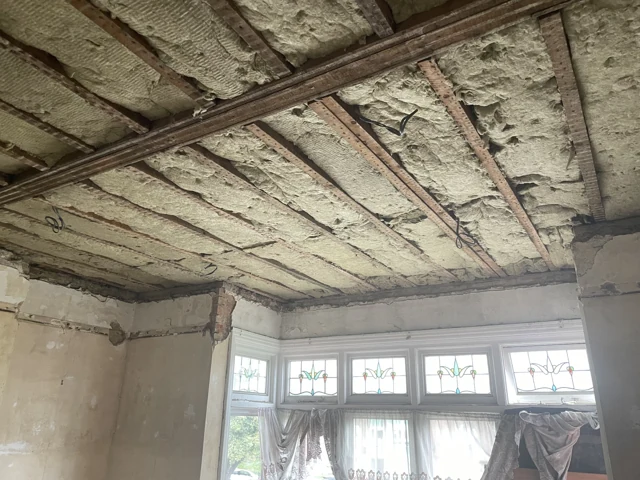 Ceiling insulation and exposed timber joists ahead of new plasterboard installation
